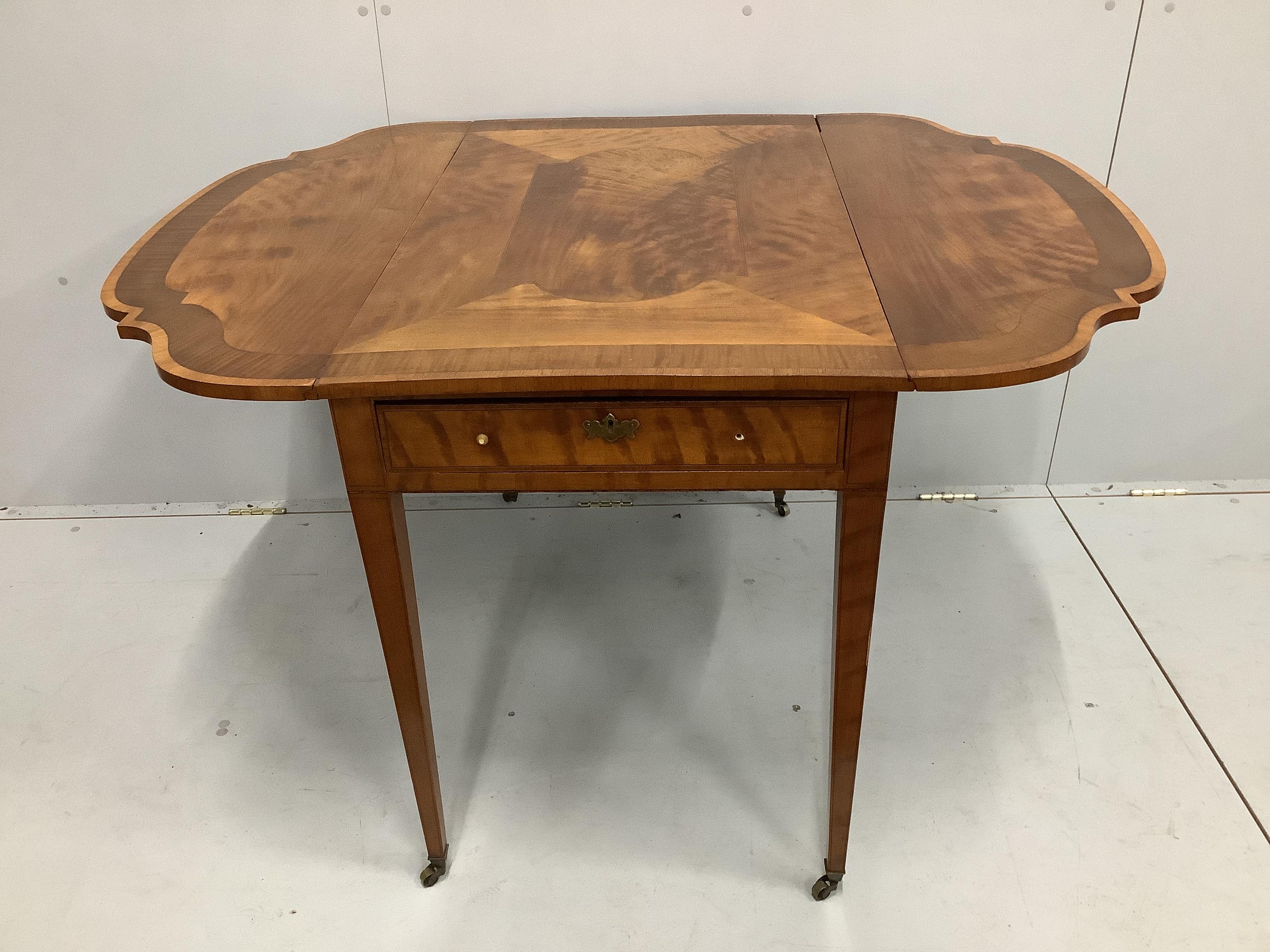 A reproduction Sheraton style sycamore banded satinwood Pembroke table, width 58cm, depth 96cm, height 73cm